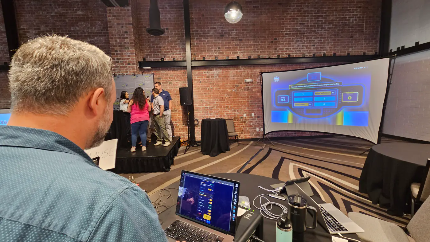 The game board live on the venue screen, with the room watching.